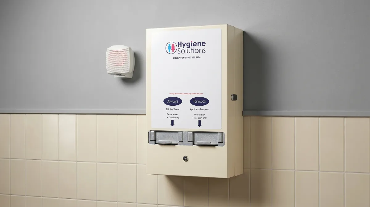Hygiene Solutions feminine hygiene vending unit mounted in a washroom