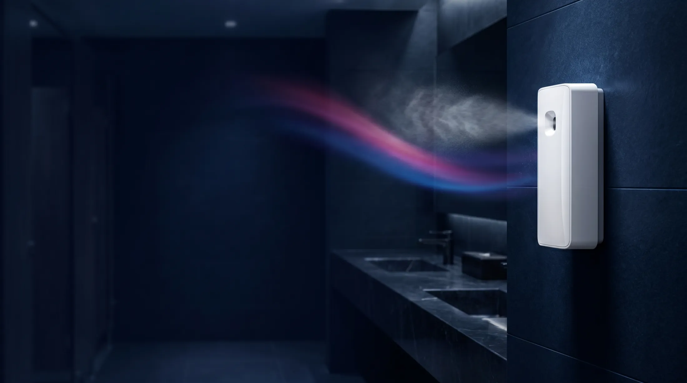 A wall-mounted automatic air freshener dispenser releasing fragrance in a washroom